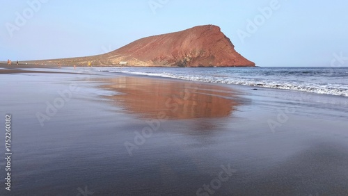 Atlantic Ocean with waves and Montana Roja mountain by La Tejita beach, Tenerife, Canary Islands