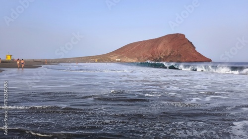 Atlantic Ocean with waves and Montana Roja mountain by La Tejita beach, Tenerife, Canary Islands