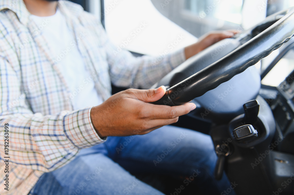 Obraz premium Professional driver holding steering wheel, operating vehicle
