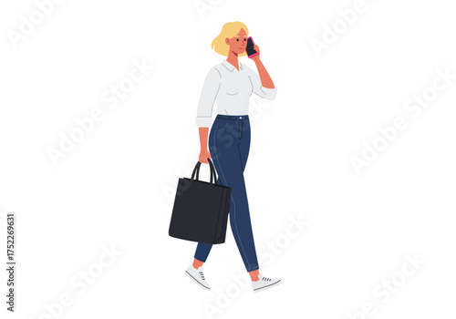 A blonde woman walking while talking on the phone and carrying a bag.