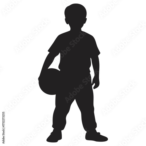 Silhouette of a boy holding a basketball