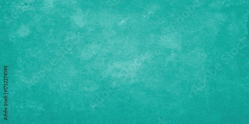 The old, dark, blue, and green grunge paper has a vintage texture and rough surface with a subtle pattern of faded paint design like an aged wallpaper backdrop