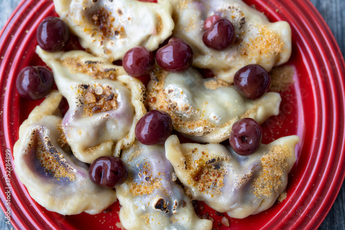 Homemade dumplings with cherries and cherries made with brown sugar compote. Homemade food