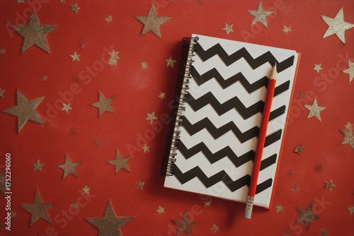 Colorful Notebook With Zigzag Design and Red Pencil on a Starry Background