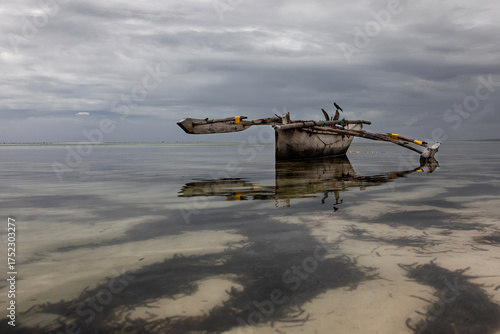 An abandoned ship stands aground. A heavenly landscape. A wooden ship. Beautiful nature. Blue sky.