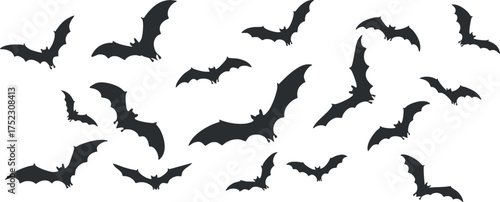 A collection of black bat silhouettes flying in a spooky Halloween scene.