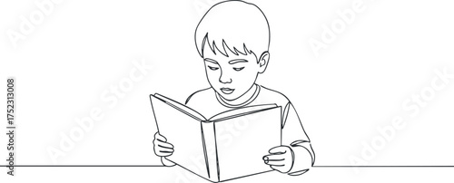 A young boy reading a book, highlighting the importance of literacy and education.