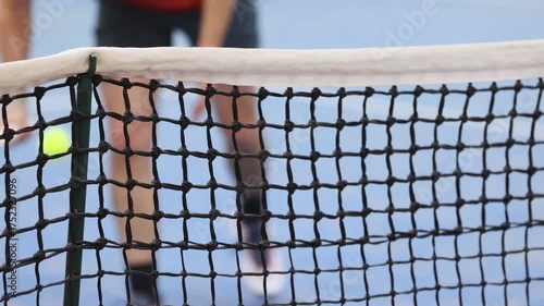 Tennis tournament championship on outdoor clay court with net, professional athletes play in motion with rackets serve tennis ball during tennis match game, tennis training in a sunny day on a stadium