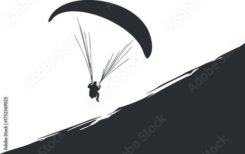 Silhouette of a paraglider descending from a hill, showcasing adventure and extreme sport.