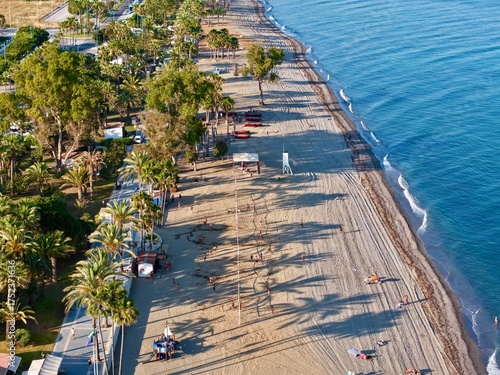 Fototapeta Naklejka Na Ścianę i Meble -  aerial view of the coast with beach and promenade with palms in San Pedro de Alcántara in beautiful light, Malaga, Costa del Sol, Andalusia, Spain