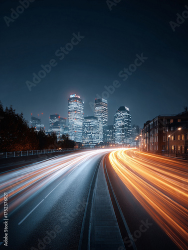Dynamic cityscape at night. Long exposure creates light trails symbolizing speed, progress, and urban life. Great for business, finance, or technology contexts.