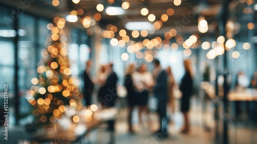 Holiday office party. Colleagues celebrating around Christmas tree. Blurred holiday background
