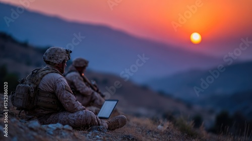 Soldiers Using Laptop at Sunset