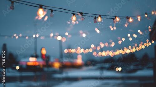 Winter string lights creating snowy evening ambiance. Blurred background