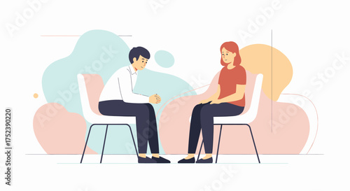 Two people sitting on chairs, engaged in a conversation or interview.