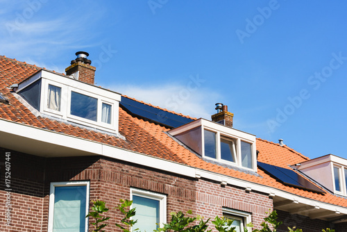 Red Brick House With Red Roof And Solar Panels