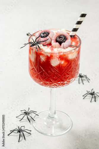 A glass of strawberry tea smoothie with whipped cream for Halloween