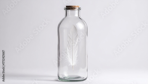 A Delicate White Feather Preserved in a Sealed Glass Bottle on a Minimalist White Background