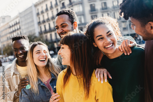 Photography Group of millennial friends laughing and talking together on a city street, enjoying time outdoors and sharing a fun social moment