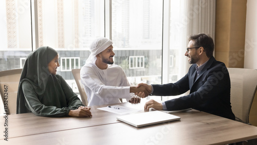 Wallpaper Mural Happy Muslim couple shake hand of realtor after signing contract Torontodigital.ca