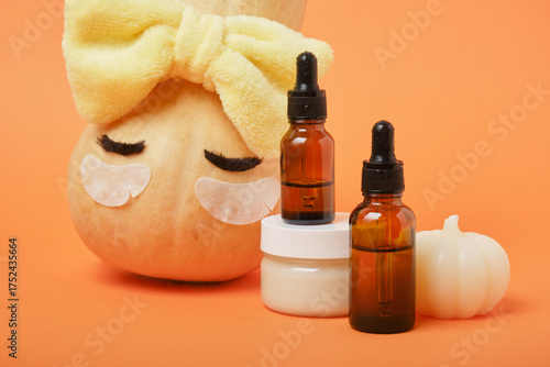 Autumn cute pumpkin with patches and cosmetic containers, autumn self-care concept