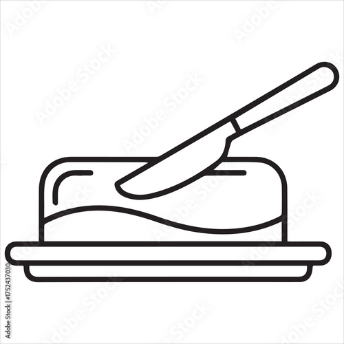 Butter dish with knife spreading butter on a slice of toast

