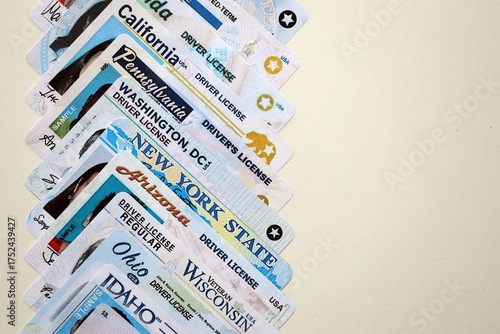 Big amount of driving licenses from different USA states. Stack of driving license specimen cards