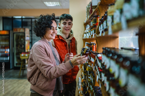 Mother and son shopping for food at grocery store