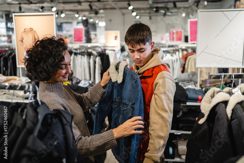 Fotografía Mother and teenage son shopping for denim jacket
