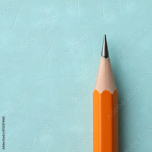 Wallpaper Mural A sharpened classic yellow wooden pencil with a graphite tip on a textured light turquoise background, cropped vertically. Generative AI. Torontodigital.ca