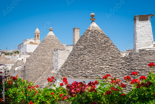 Beautiful roof garden and old stone trulli houses with conical roofs in Alberobello, Puglia, Italy.
