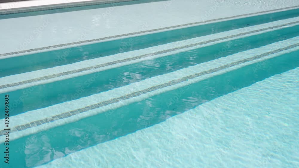 Swimming pool with several lanes. Lanes are marked by dark lines on the ...