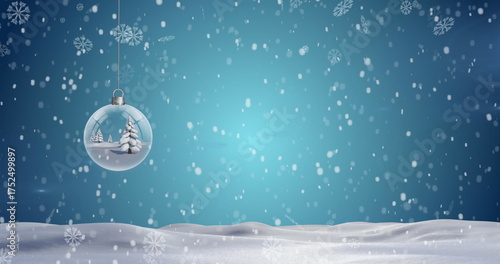 Christmas tree in a hanging bauble decoration and snowflakes falling over winter landscape