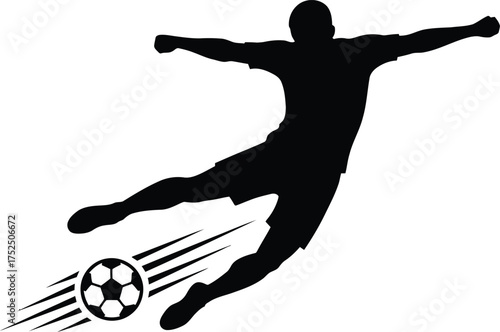 Silhouette of a soccer player kicking a ball in mid air
