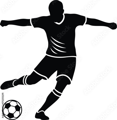 Silhouette of a soccer player kicking a ball
