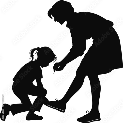 Mother helping child put on shoes silhouette