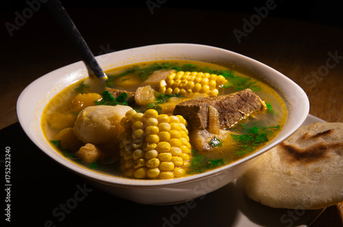 Close up of Venezuelan soup with arepa and lime, traditional Latin American cuisine