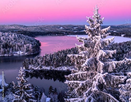 Winter landscape with snowy pine trees, frozen lake, and pink sunset sky in serene mountain scenery