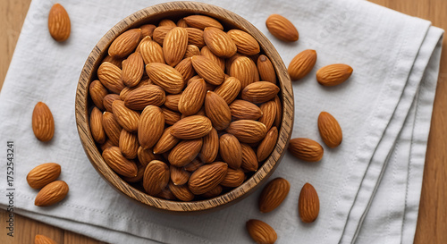 Almonds in a wooden bowl on linen