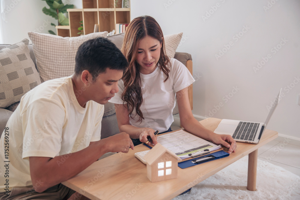 Obraz premium Couple lover make home financial plan. Young asian lover planning retire plan at home bedroom look at investment graph chart. Family finance investment happy together.