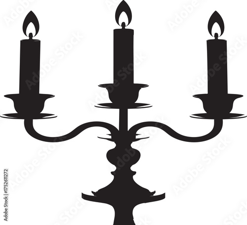 A black candelabra with three lit candles standing on a reflective dark surface against a white background