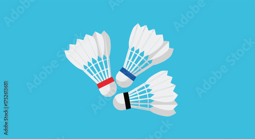 Three white shuttlecocks with colored bands arranged in a playful cluster on a vibrant blue background.