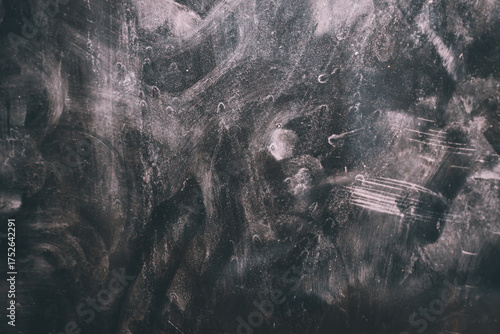 Background on dirty and dusty frosted glass. Dull frosted glass surface with dirty stains and spots.