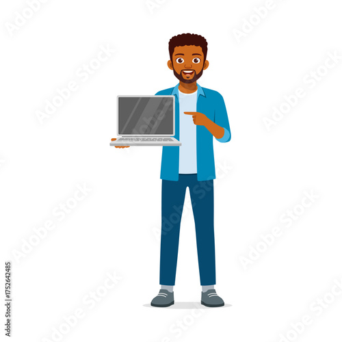 African man holding and pointing at laptop screen with happy expression in full body shot