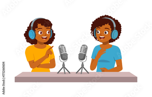Two African American women podcasting wearing headphones smiling and gesturing at microphones