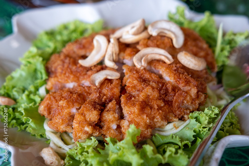 Fried chicken served on plate with cashew nut