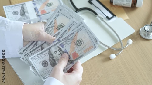 Doctor holding dollar bills with stethoscope and medicine on desk, concept of medical expenses, healthcare finance, and hospital business management.