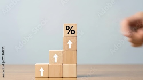 Conceptual growth represented by wooden blocks stacked in a staircase pattern with upward arrows and a percentage symbol
