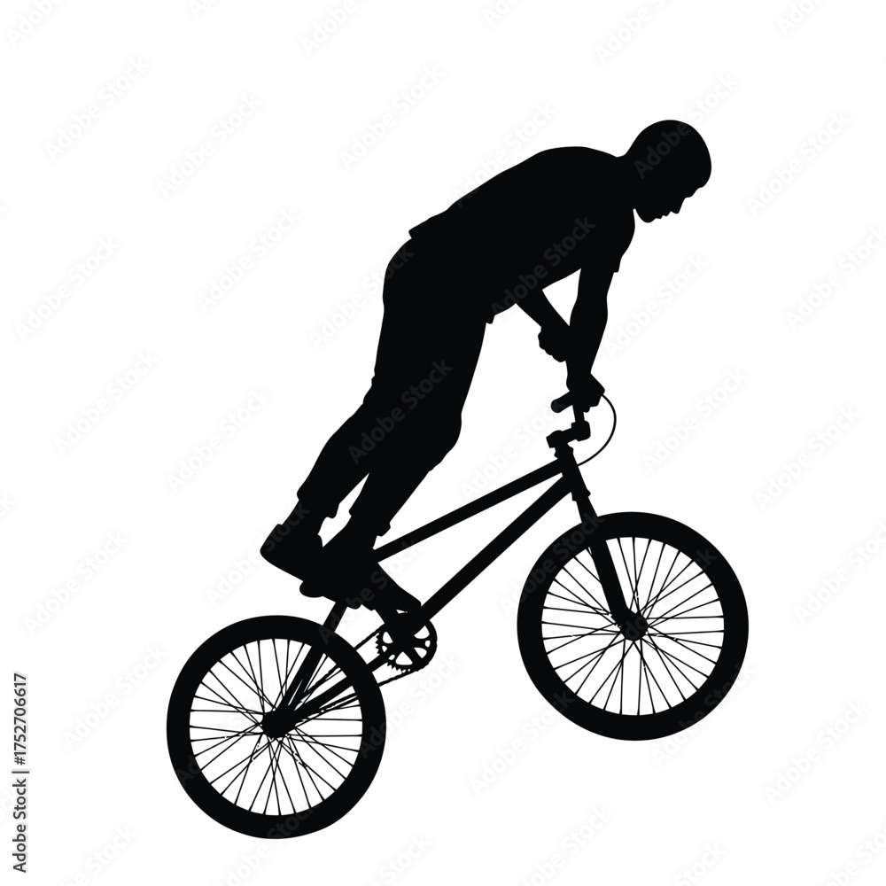 Naklejka premium Dynamic silhouette of a bmx rider performing a wheelie stunt against a silhouette