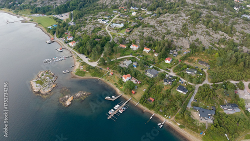 Top-Down Aerial View of Seaside Residential Area Near Strömstad, Sweden with Docks, Houses, Rocky Terrain, and Forested Hills by a Calm Coastline